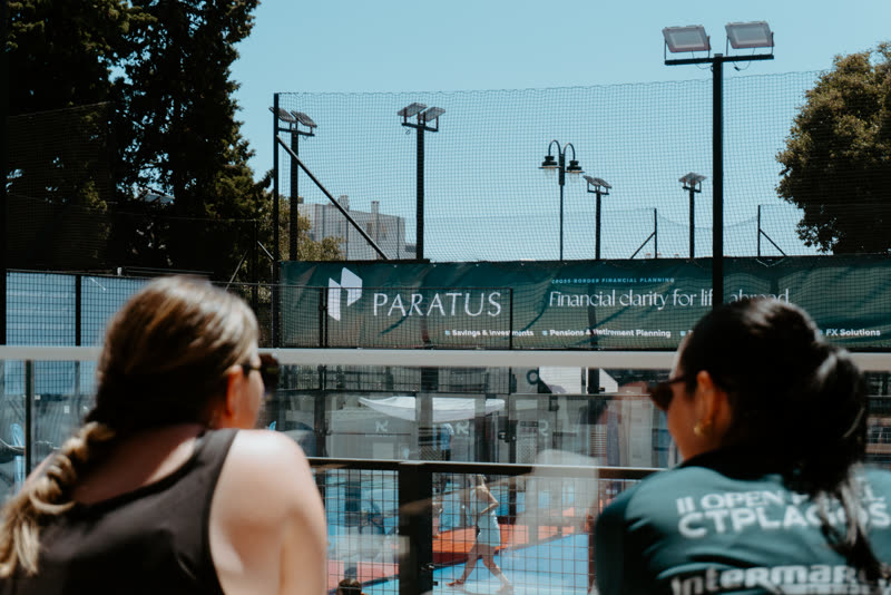 Spectators watching a match beside the Paratus Wealth Financial clarity for life abroad banner
